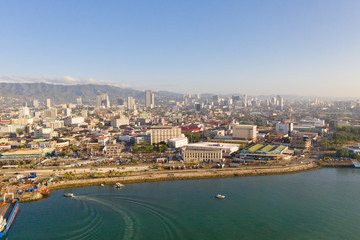 Fototapeta na wymiar Cityscape in the morning. The streets and houses of the city of Cebu, Philippines, top view. Panorama of the city with houses and business centers.