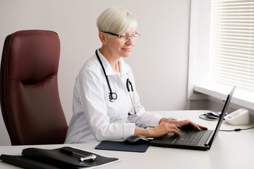 Doctor typing on the computer. Reception at the doctor's office. Hospital and medicine