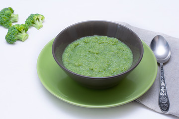 Vegetarian soup of broccoli puree on a white background. The concept of healthy eating.