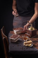 girl preparing tiramisu dessert on the kitchen table