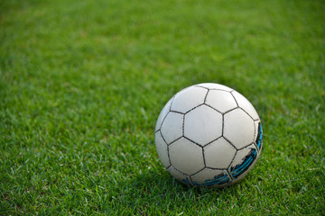 Soccer ball on the green lawn of a football field