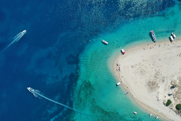 Aerial drone view of iconic small uninhabited island of Marathonisi featuring clear water, sandy shore and natural hatchery of Caretta-Caretta sea turtles, Zakynthos, Greece