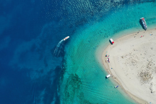 Aerial drone view of iconic small uninhabited island of Marathonisi featuring clear water, sandy shore and natural hatchery of Caretta-Caretta sea turtles, Zakynthos, Greece