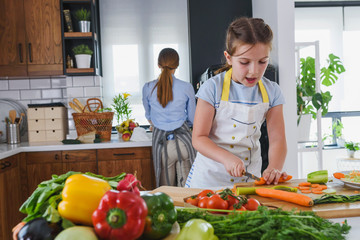 Mother Teaching Child to Cook and Help in the Kitchen. Mother and Daughter