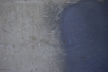 The texture of the old scratched plaster, painted with gray and dark blue paint