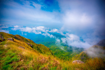 Landscape of sunrise on Green mountains and beautiful sky clouds under the blue sky, Dramatic moving cloud in nature landscape, Sunshine morning. - Image