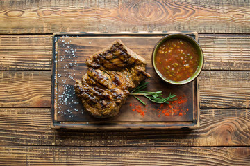 Grilled meat on a wooden table.