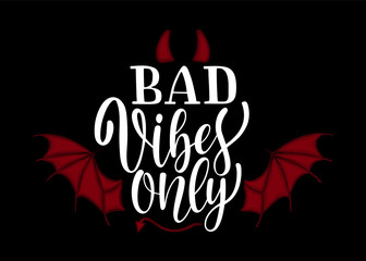 Handwritten phrase Good vibes only with devils wings, tail and horns text for clothes. Funny quote on the black background. Lucky for print, postcard or poster. Vector illustration.
