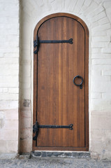Old Russian heavy wooden doors of brown color.