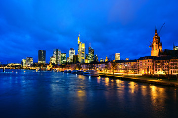Obraz premium Skyline of Frankfurt, Germany in the sunset with famous illuminated skyscrapers