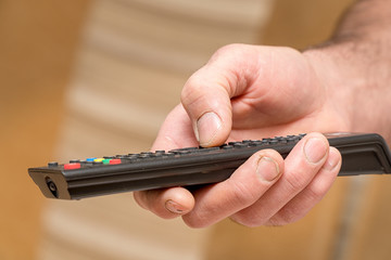 TV remote in the hand of man