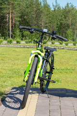 Green sport bike in the park.  Front view