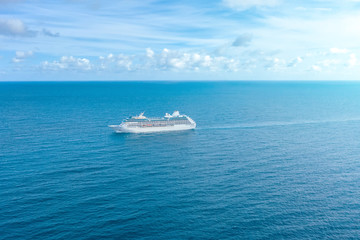 Fototapeta na wymiar Cruise ship liner sails in the blue sea leaving a plume, seascape. Aerial view The concept of sea travel, cruises.