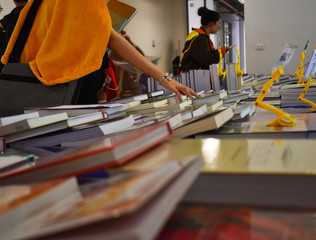 People stand choose books in book fair