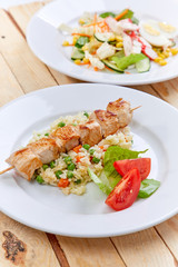 chicken kebab with rice and vegetables