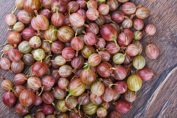 Ripe berries of a gooseberry on a wooden table. Top view