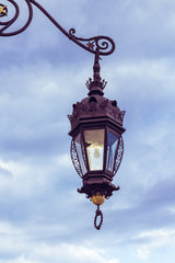Fototapeta na wymiar Old lantern, medieval street light in the street on the light background in Krakow. Poland