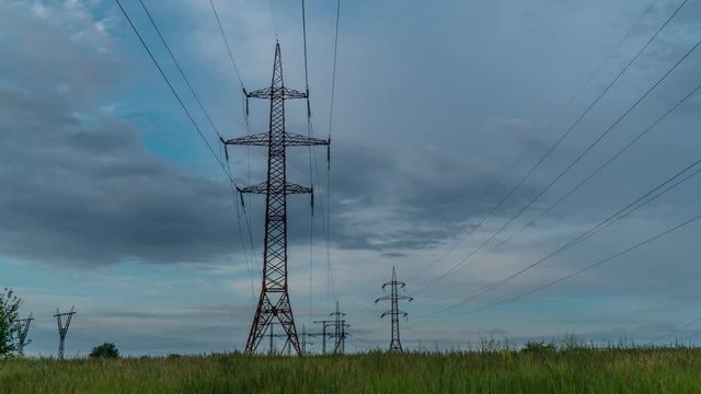 Electricity pylons and beautiful clouds. Timelapse. Zoom out. 4K