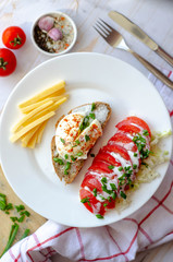 healthy breakfast with poached egg, whole wheat bread, tomatoes and cheese. proper nutrition diet