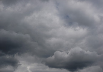 a small plane in dense gray rain clouds
