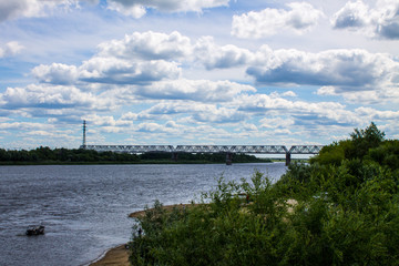Fototapeta premium Summer landscape on the Oka river in Murom, Russia with a railway bridge