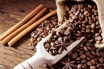 Roasted coffee beans in bag and coffee beans around