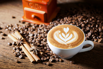 white coffee cup and roasted coffee beans around