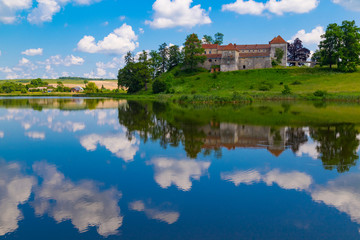 Fototapeta na wymiar Old beautiful Svirzh castle, surrounded by lake . Ukraine