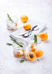 Natural yogurt with pieces of apricots and rosemary