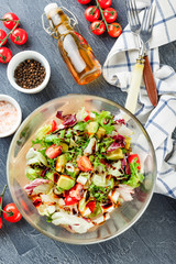 Salad with lettuce, cherry tomatoes, romano lettuce, frisse, lollo rosso, feta cheese and avocado