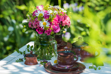 Summer flower bouquet on a garden table