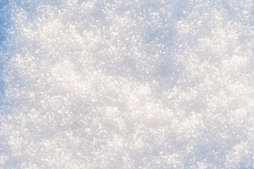 winter background, snow texture. snowflakes close up. shiny snowflakes in the rays of the sun