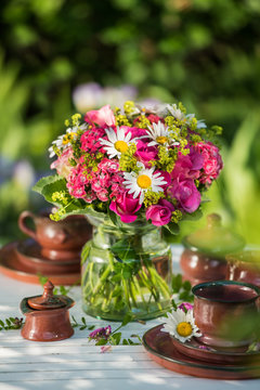 Summer flower bouquet on a garden table