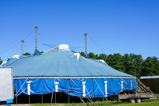 traveling circus blue tent against a blue sky