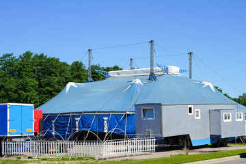 Fototapeta na wymiar traveling circus blue tent against a blue sky