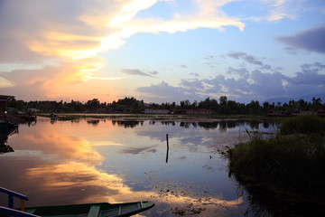 increíble atardecer en cachemira India. Colores de ensueño. Ambiente de relax en tonos purpuras, rojos, azules y amarillos. Srinagar. Reflejo y barca