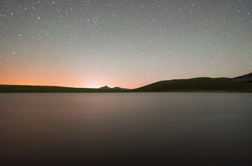 Fototapeta na wymiar Night landscape. Beautiful lake and mountains at the night.
