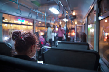 People in old public bus, view from inside the bus . People sitting on a comfortable bus in Selective focus and blurred background. s the main mass transit passengers in the bus. - obrazy, fototapety, plakaty