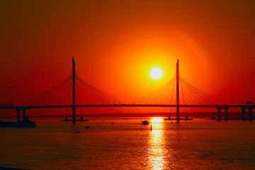 Fototapeta na wymiar cable bridge silhouette against the setting sun