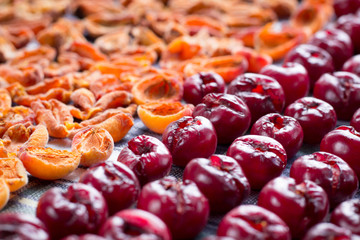 Background of fresh mellow cherries and apricots prepared for conservation