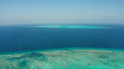 Fototapeta na wymiar Tropical islands and coral atolls with blue water of the sea, aerial view. Balabac, Palawan, Philippines. Summer and travel vacation concept.