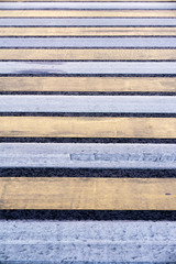 Pedestrian crossing. Road markings on asphalt. Striped blue and yellow background and texture