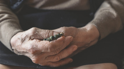 old wrinkled hands of elderly woman. praying woman.