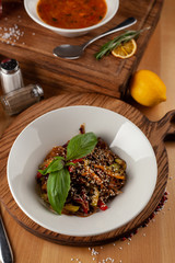 Thai buckwheat noodles with vegetables and sesame, flavoured with oyster sauce on a wooden table with ingredients