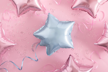 Festive pink background. Shining light blue and pink stars, shining balloons on light pink pastel background. Christmas. Wedding. Birthday. Flat lay, top view, copy space