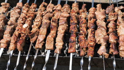 Background from grilled meat platter marinated juicy natural high-calorie meat ram, beef, pork, chicken fillet on the grill. BBQ party for a big company