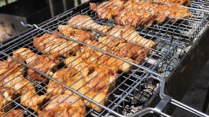 Chicken marinated juicy natural dietary Legs on the Grill. BBQ party for a big company.