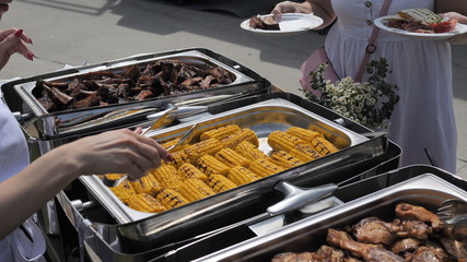 Dishes from natural and organic meat Corn Vegetables Burger cooked on the Grill are served to guests. Slow motion 4K
