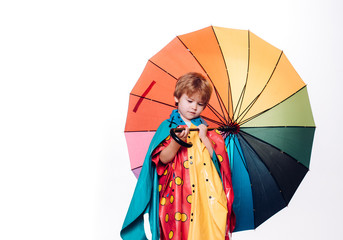 Little boy with rainbow-colored umbrella isolated on white background. Sale for entire autumn collection, incredible discounts and wonderful choice. Cloud rain umbrella. Raining concept.