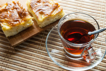 Turkish su boregi, burek or borek, turkish water patty slices with cheese and turkish tea, traditional turkish stuffed filo dough cheesy pastry food